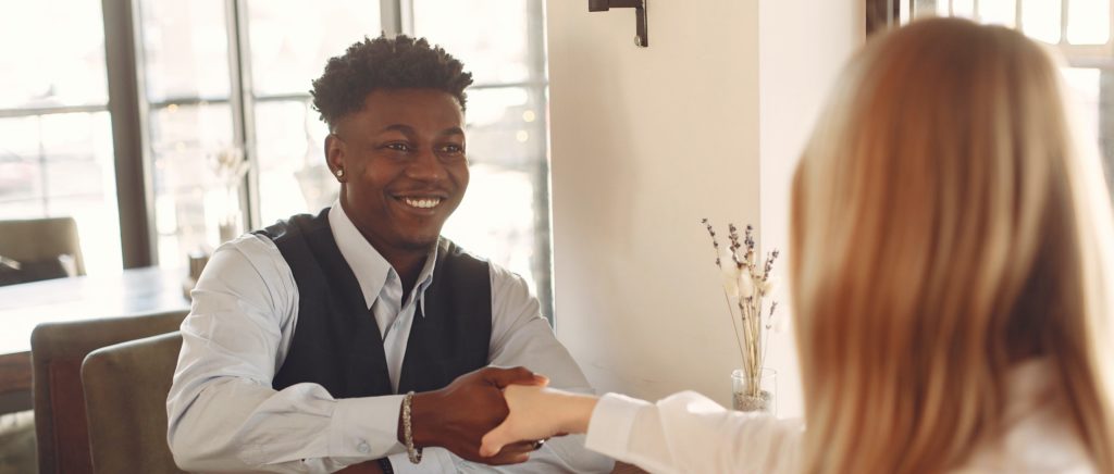 Man and Woman sitting and shaking hands