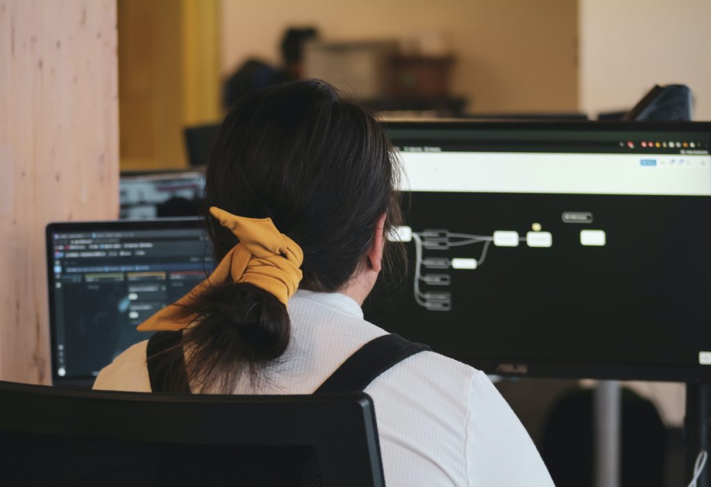 Seated woman typing on a monitor